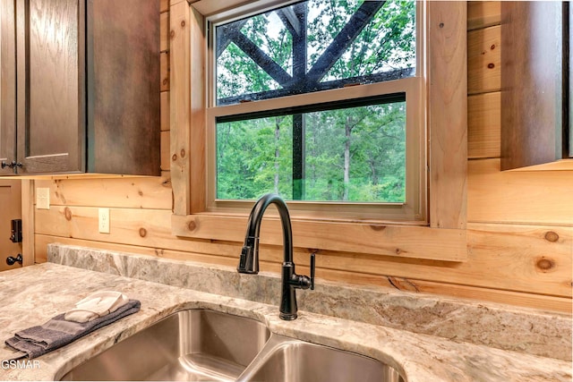kitchen view of a sink and light stone counters