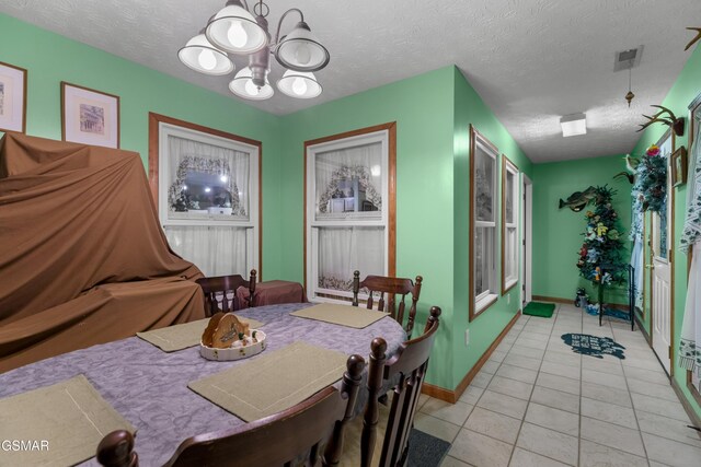 1878 Omaha Rd, Del Rio, TN 37727 - dining area with a chandelier, light tile patterned flooring, baseboards, and a textured ceiling
