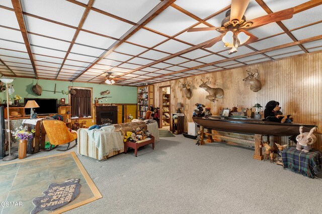 1878 Omaha Rd, Del Rio, TN 37727 - carpeted living room featuring a ceiling fan, a fireplace, and wood walls