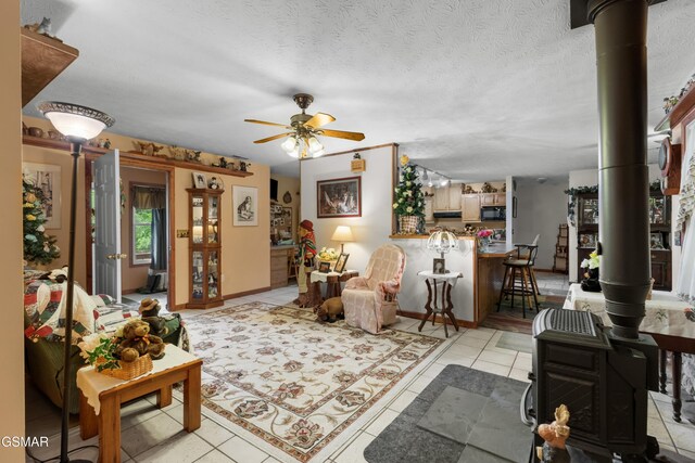 1878 Omaha Rd, Del Rio, TN 37727 - living room with ceiling fan, light tile patterned flooring, and a wood stove