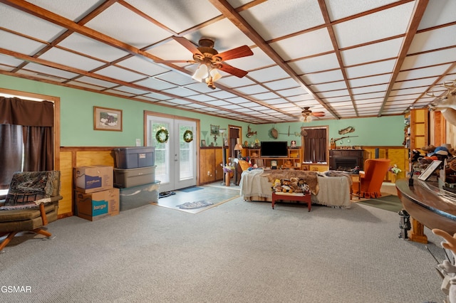 1878 Omaha Rd, Del Rio, TN 37727 - living area featuring a ceiling fan, wainscoting, carpet, a fireplace, and wood walls