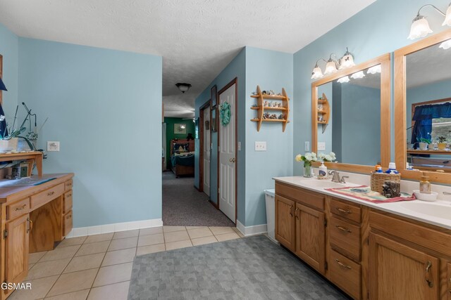 1878 Omaha Rd, Del Rio, TN 37727 - bathroom featuring connected bathroom, tile patterned flooring, double vanity, a textured ceiling, and baseboards