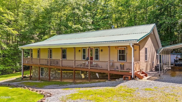 1878 Omaha Rd, Del Rio, TN 37727 - view of front facade featuring metal roof, covered porch, a detached carport, and a view of trees
