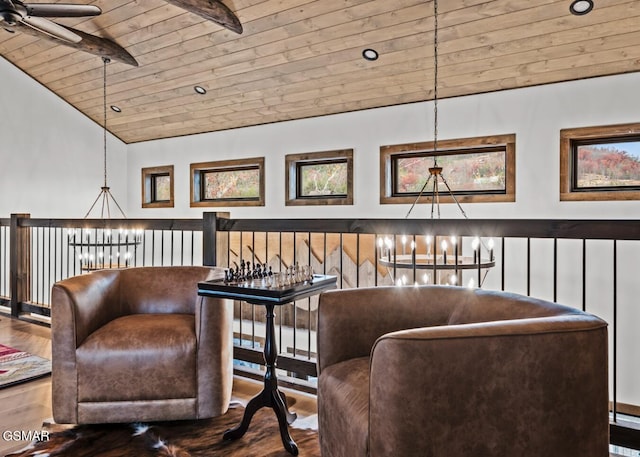 sitting room featuring hardwood / wood-style flooring, lofted ceiling, ceiling fan with notable chandelier, and wooden ceiling