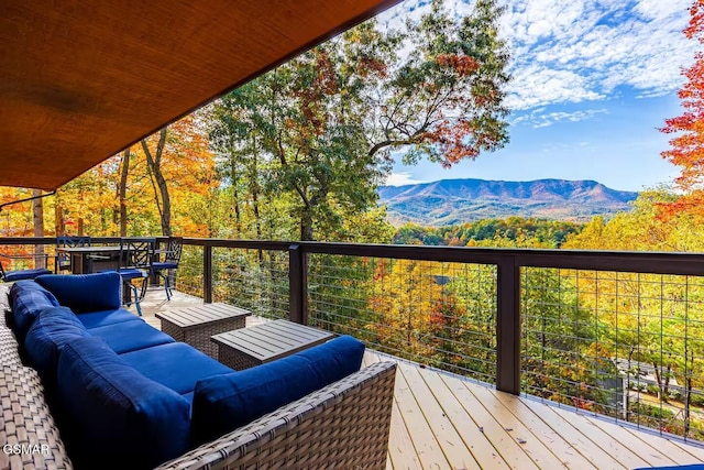 wooden deck featuring an outdoor hangout area and a mountain view