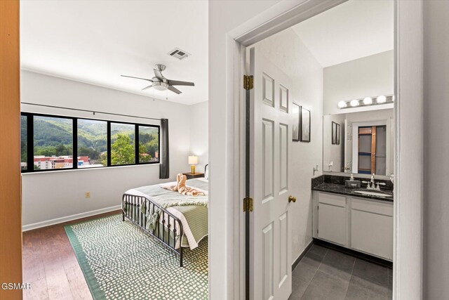 bedroom with ceiling fan and sink