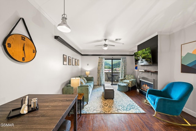 living room with dark hardwood / wood-style flooring, ceiling fan, and ornamental molding