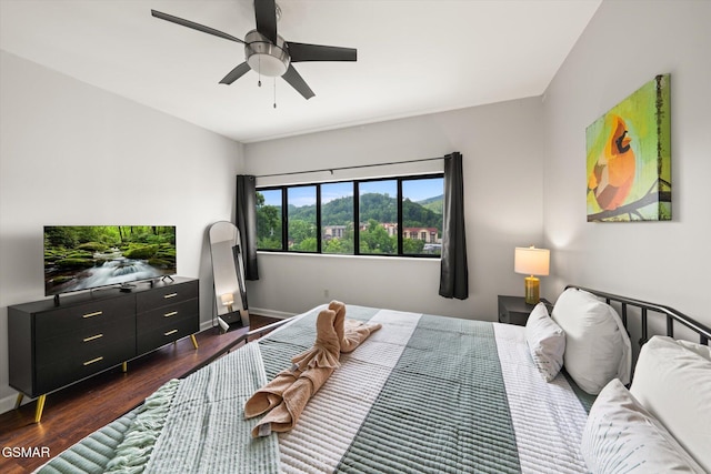 bedroom with ceiling fan and dark wood-type flooring