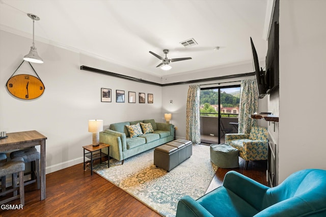 living room with ceiling fan, dark hardwood / wood-style flooring, and crown molding