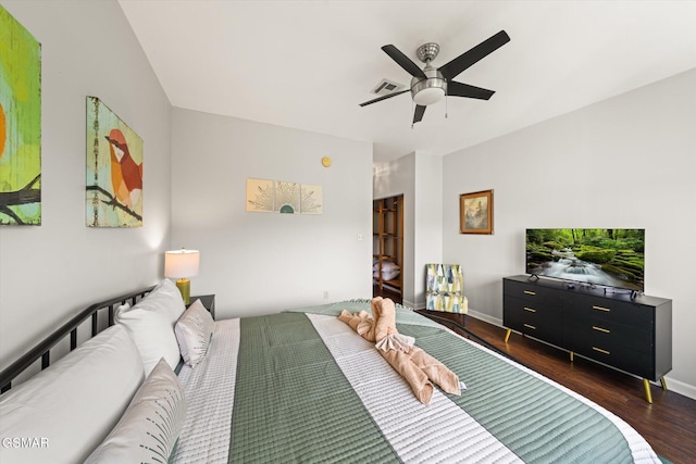 bedroom with ceiling fan and dark hardwood / wood-style flooring