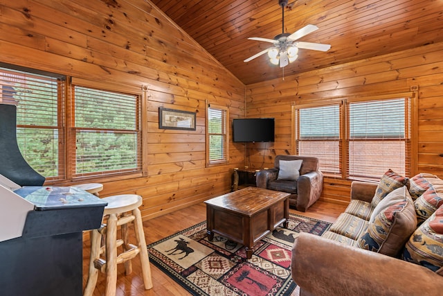 living room with vaulted ceiling, wooden walls, wood ceiling, ceiling fan, and wood-type flooring