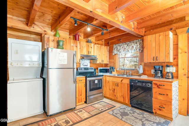 kitchen with rail lighting, sink, stacked washer and dryer, appliances with stainless steel finishes, and beam ceiling