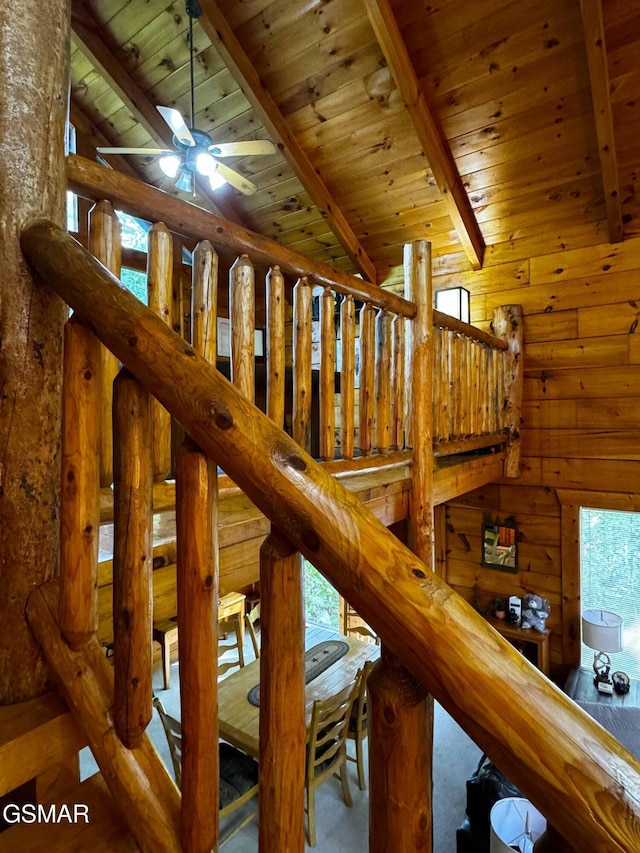 stairs with lofted ceiling with beams, ceiling fan, and wood ceiling