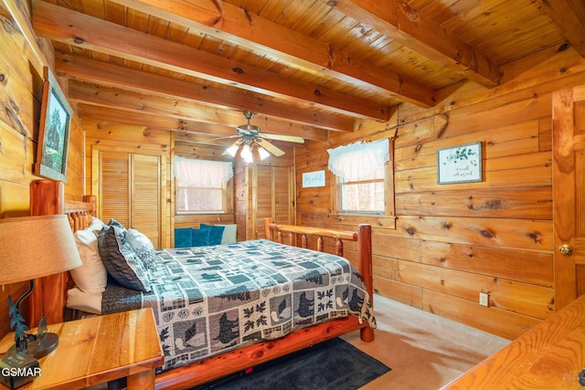 carpeted bedroom with multiple windows, wooden walls, beamed ceiling, and wood ceiling