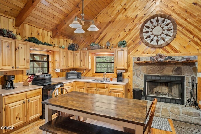4164 Lumber Jack Way, Sevierville, TN 37876 - kitchen with black appliances, a sink, light wood-style flooring, light countertops, and wood walls