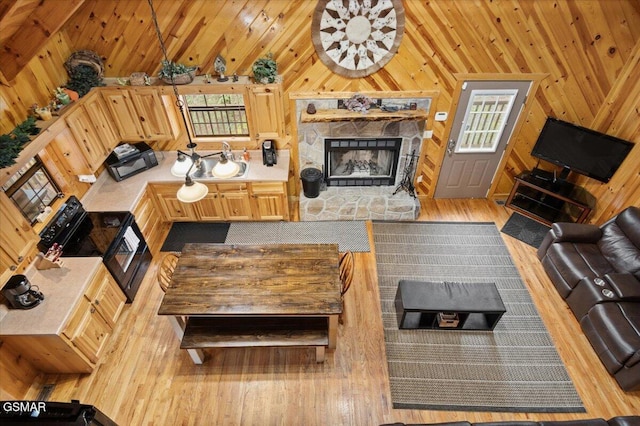 4164 Lumber Jack Way, Sevierville, TN 37876 - living room featuring hardwood / wood-style floors, a stone fireplace, wood walls, and vaulted ceiling