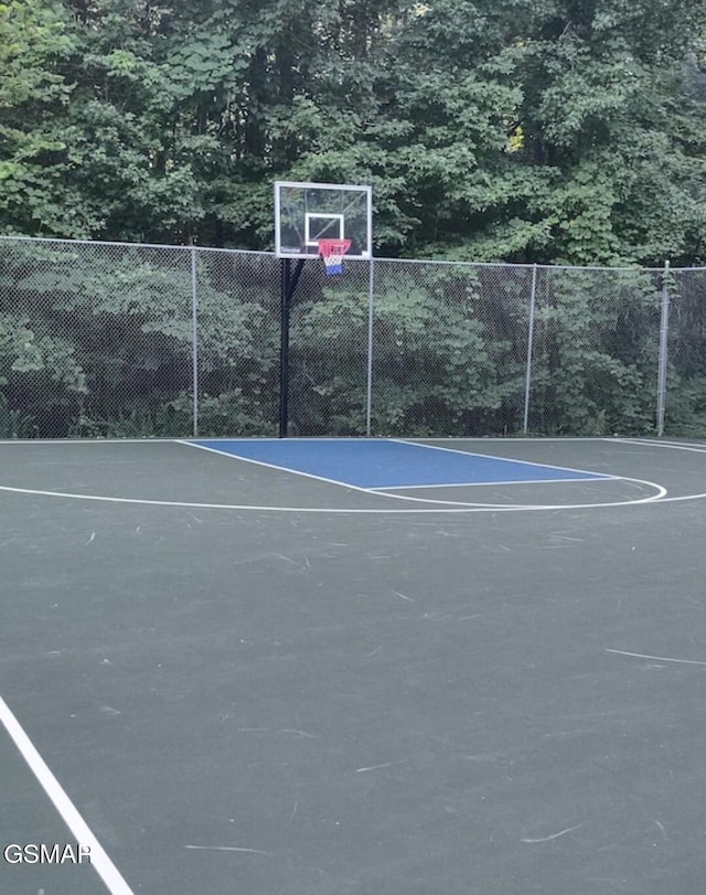 view of basketball court with community basketball court and fence