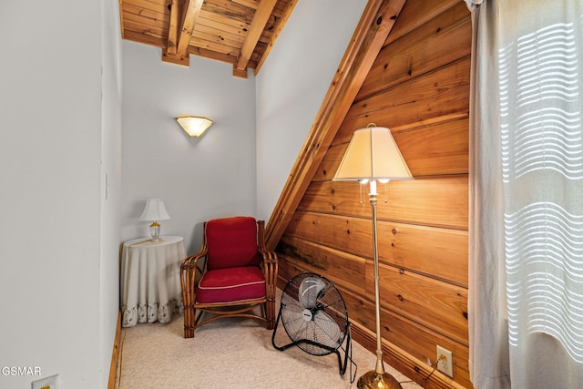 sitting room featuring carpet floors, wood ceiling, and lofted ceiling with beams