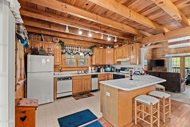 kitchen featuring rail lighting, wood ceiling, under cabinet range hood, and white appliances