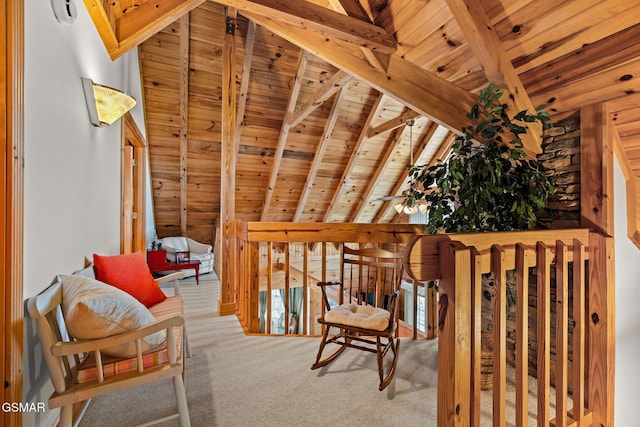 unfurnished room with an upstairs landing, wooden ceiling, carpet flooring, and lofted ceiling with beams