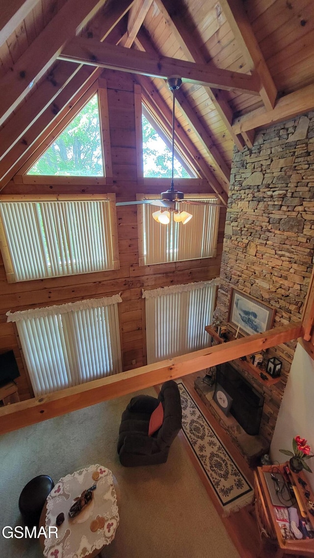 living area featuring lofted ceiling with beams, an inviting chandelier, and wood ceiling