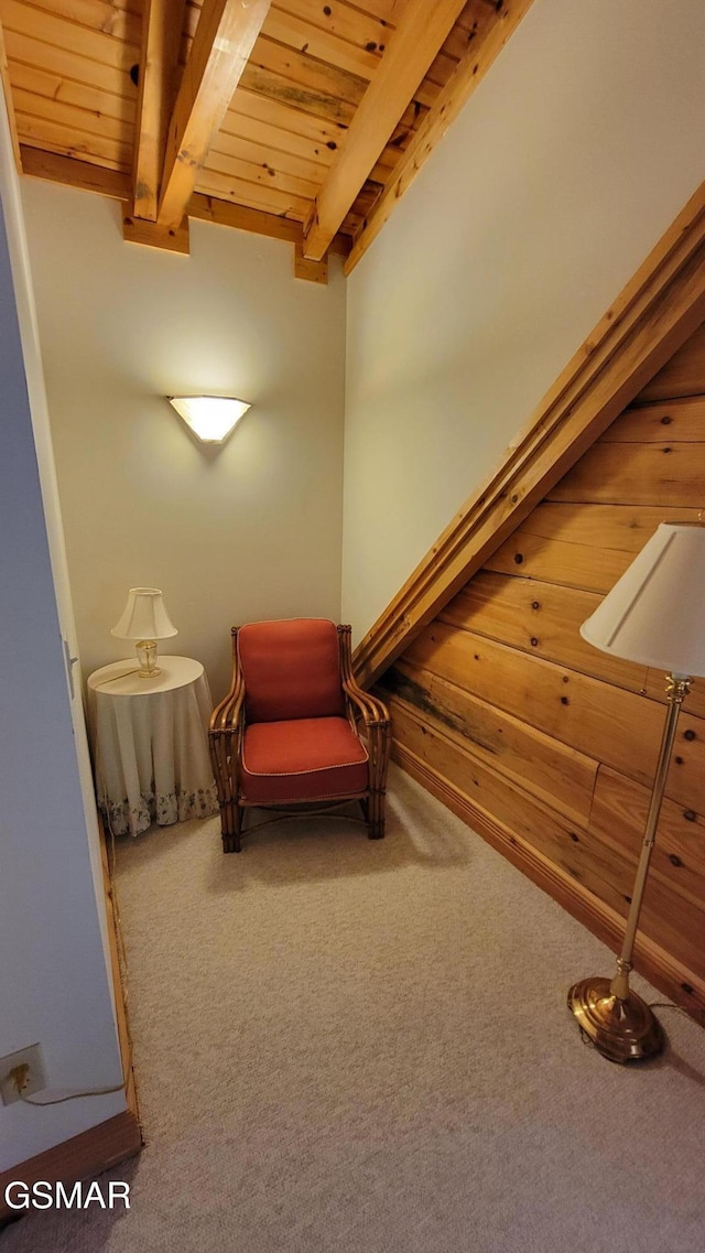 unfurnished room featuring carpet floors, beamed ceiling, and wood ceiling