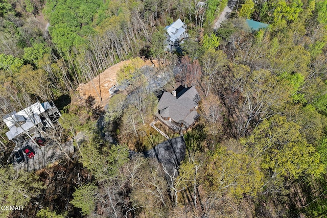 bird's eye view featuring a wooded view