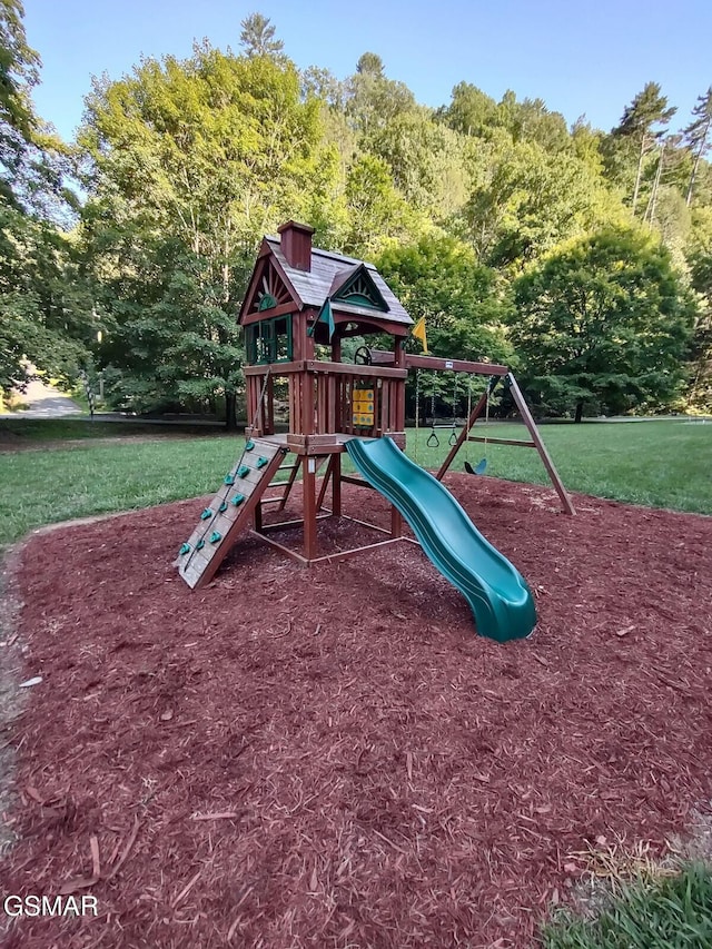 view of playground with a lawn