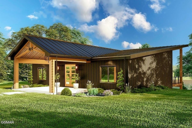 rear view of property with metal roof, a lawn, and a standing seam roof