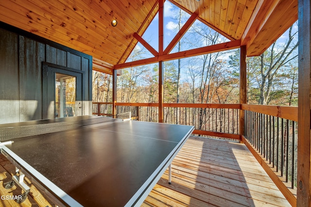 playroom with a healthy amount of sunlight, a wall of windows, light wood-type flooring, and wood ceiling