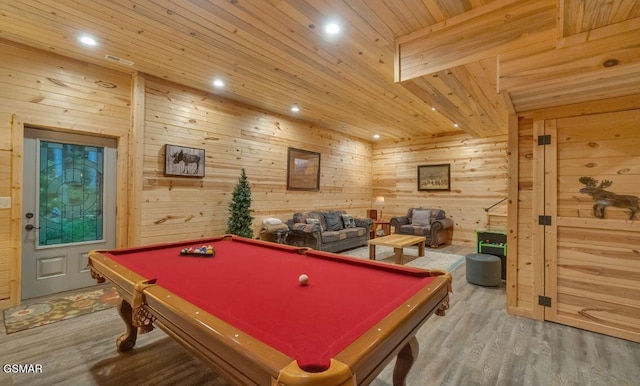 playroom featuring hardwood / wood-style floors, wooden walls, and pool table