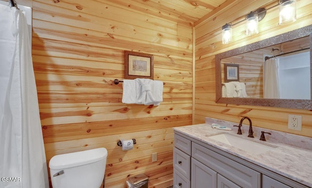 bathroom with vanity, toilet, walk in shower, and wood walls