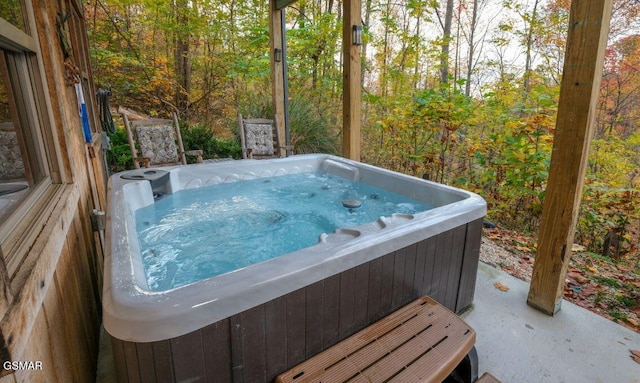 view of pool with a hot tub