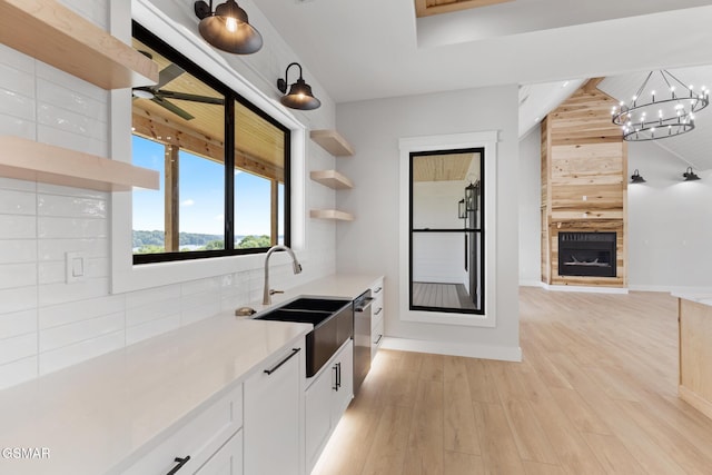 206 Eagle View Dr, Dandridge, TN 37725 - kitchen with open shelves, dishwasher, decorative backsplash, a chandelier, and light wood finished floors