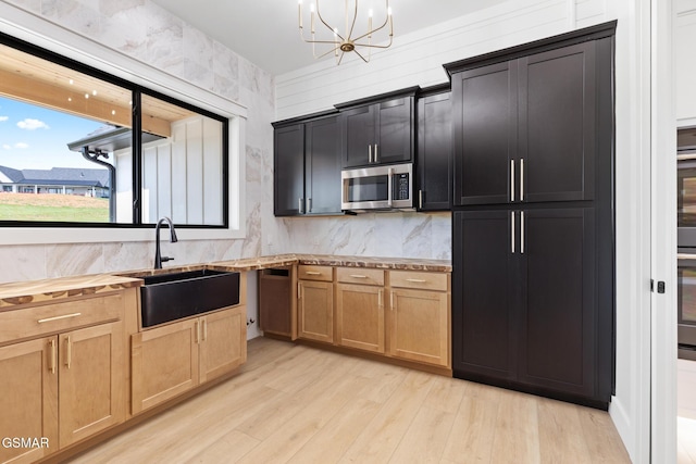 206 Eagle View Dr, Dandridge, TN 37725 - kitchen with stainless steel microwave, light wood-style flooring, a chandelier, wooden counters, and light brown cabinets