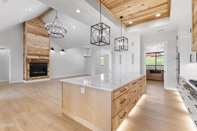 206 Eagle View Dr, Dandridge, TN 37725 - kitchen with wooden ceiling, a chandelier, light wood-style flooring, a fireplace, and light stone countertops