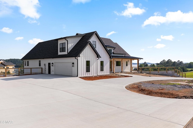 206 Eagle View Dr, Dandridge, TN 37725 - modern farmhouse style home with board and batten siding, concrete driveway, a shingled roof, a garage, and a porch