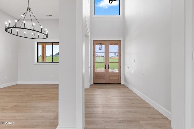 206 Eagle View Dr, Dandridge, TN 37725 - entryway with a chandelier, light wood-type flooring, a high ceiling, and french doors