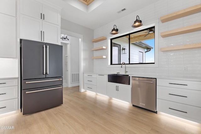 206 Eagle View Dr, Dandridge, TN 37725 - kitchen featuring stainless steel dishwasher, freestanding refrigerator, open shelves, backsplash, and light countertops