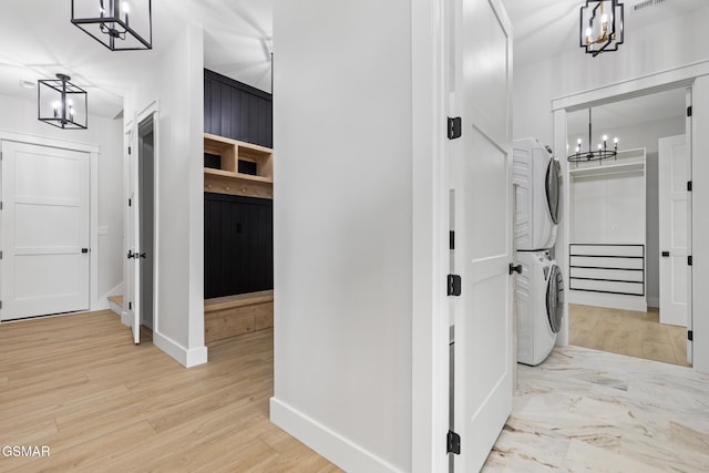 206 Eagle View Dr, Dandridge, TN 37725 - corridor featuring stacked washing machine and dryer, a chandelier, stairs, and light wood-style flooring
