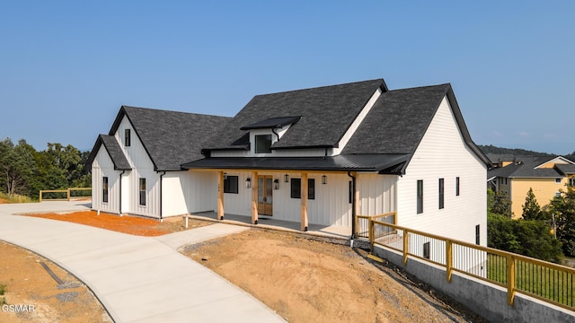 206 Eagle View Dr, Dandridge, TN 37725 - modern inspired farmhouse with a shingled roof, a porch, a standing seam roof, and a metal roof