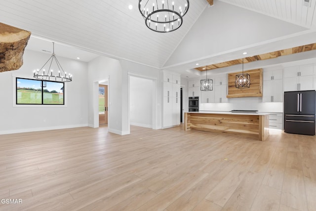 206 Eagle View Dr, Dandridge, TN 37725 - unfurnished living room featuring a chandelier, light wood finished floors, beamed ceiling, recessed lighting, and high vaulted ceiling