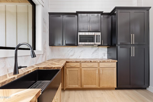 206 Eagle View Dr, Dandridge, TN 37725 - kitchen with stainless steel microwave, wood counters, decorative backsplash, and light wood-style flooring