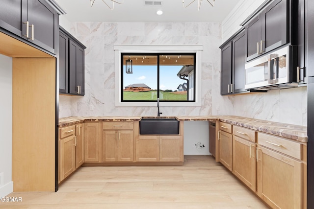 206 Eagle View Dr, Dandridge, TN 37725 - kitchen featuring stainless steel microwave, light wood finished floors, backsplash, and light brown cabinetry