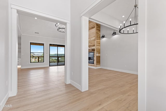 206 Eagle View Dr, Dandridge, TN 37725 - hallway with a chandelier, wood finished floors, a towering ceiling, wood walls, and recessed lighting