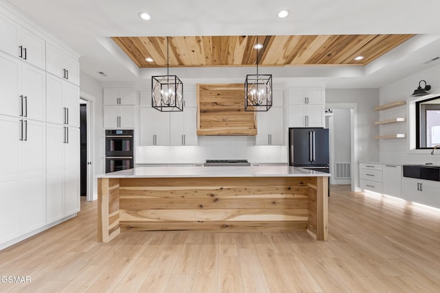 206 Eagle View Dr, Dandridge, TN 37725 - kitchen with a tray ceiling, appliances with stainless steel finishes, a chandelier, decorative backsplash, and recessed lighting