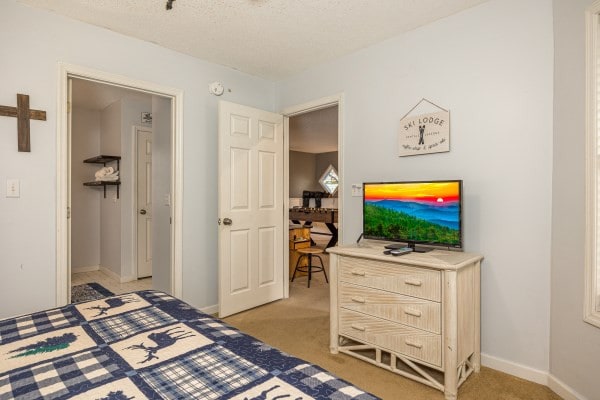 carpeted bedroom with a textured ceiling