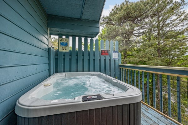 wooden deck with a hot tub