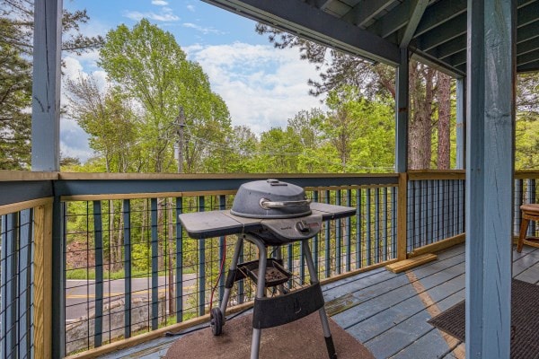 wooden terrace featuring grilling area