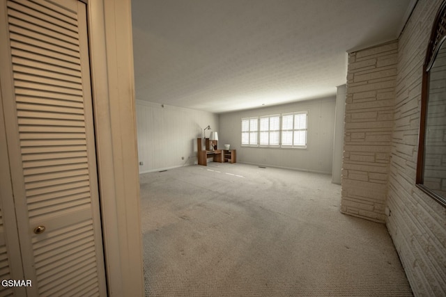 basement featuring light colored carpet